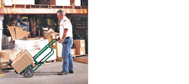 man with handtruck lifting boxes