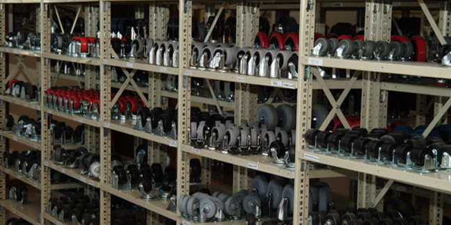 Large quantity of casters on shelves